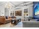 Bright living room with leather sofa, decor pillows, and stylish light fixture at 4 Beaufain St # 207, Charleston, SC 29401