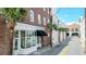 A view of the building's street with palm trees and sidewalk at 4 Beaufain St # 207, Charleston, SC 29401