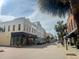 A vibrant street view featuring historic buildings and palm trees on a sunny day at 4 Beaufain St # 207, Charleston, SC 29401