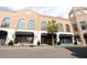 Wide street view showcases storefronts of brand name stores, brick buildings and palm trees at 4 Beaufain St # 207, Charleston, SC 29401