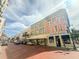 A vibrant street view featuring colorful buildings and stores along the sidewalk at 4 Beaufain St # 207, Charleston, SC 29401