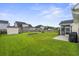 Wide backyard view showcasing a storage shed, well-kept lawn, screened porch, and privacy fence at 411 Topcrest Ln, Moncks Corner, SC 29461