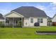 Spacious backyard with a screened porch, patio, and well-maintained lawn, perfect for outdoor activities at 411 Topcrest Ln, Moncks Corner, SC 29461