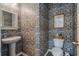 Charming powder room features stylish wallpaper, a pedestal sink, and a toilet at 411 Topcrest Ln, Moncks Corner, SC 29461