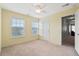 Bright, carpeted bedroom with two windows and a ceiling fan offers a comfortable and airy space at 411 Topcrest Ln, Moncks Corner, SC 29461