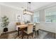 Elegant dining room with modern lighting, wainscoting, and hardwood floors for stylish entertaining at 411 Topcrest Ln, Moncks Corner, SC 29461