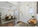 Inviting home foyer with hardwood floors, elegant lighting, and views into the dining room at 411 Topcrest Ln, Moncks Corner, SC 29461