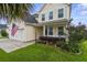Charming two-story home featuring a well-manicured lawn, two-car garage, and a classic blue front door at 411 Topcrest Ln, Moncks Corner, SC 29461