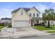 Charming two-story home featuring a well-manicured lawn, two-car garage, and a classic blue front door at 411 Topcrest Ln, Moncks Corner, SC 29461