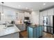 Well-lit kitchen boasts stainless steel appliances, island, and granite countertops at 411 Topcrest Ln, Moncks Corner, SC 29461