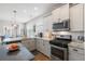 Bright kitchen features modern stainless steel appliances and granite countertops at 411 Topcrest Ln, Moncks Corner, SC 29461
