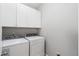Neat laundry area featuring a washer, dryer, and overhead cabinets perfect for space saving and organization at 411 Topcrest Ln, Moncks Corner, SC 29461