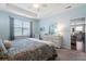 Tranquil main bedroom features light-blue walls, a tray ceiling, and a large window at 411 Topcrest Ln, Moncks Corner, SC 29461