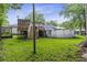 Backyard deck, pool, lush grass, and mature trees creating a serene outdoor space for relaxation at 414 Birch Ave, Goose Creek, SC 29445