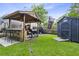 Backyard with outdoor kitchen, bar and grilling area, a storage shed, and green lawn at 414 Birch Ave, Goose Creek, SC 29445