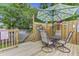 Backyard patio with table under umbrella and decorative wood fence at 414 Birch Ave, Goose Creek, SC 29445