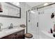 This bathroom features a sliding glass door shower, vanity, and decorative wallpaper at 414 Birch Ave, Goose Creek, SC 29445