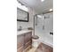 This bathroom features a sliding glass door shower, vanity, and decorative wallpaper at 414 Birch Ave, Goose Creek, SC 29445