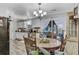 Dining area with a wooden table set, stylish chandelier, and sliding glass doors leading to outdoor patio at 414 Birch Ave, Goose Creek, SC 29445