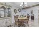 Charming dining area with wood table set, decorative china cabinet, and view into the living space at 414 Birch Ave, Goose Creek, SC 29445