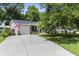 Charming home with a well-manicured lawn, inviting driveway, attached garage and beautiful flowering trees at 414 Birch Ave, Goose Creek, SC 29445