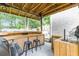 Covered outdoor kitchen with bar seating and a grilling area at 414 Birch Ave, Goose Creek, SC 29445