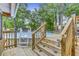 An exterior view of a backyard pool with a wooden deck and ladder, perfect for summer enjoyment at 414 Birch Ave, Goose Creek, SC 29445