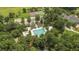 Aerial view of community pool, tennis courts, clubhouse, and playground surrounded by lush greenery and trees at 4272 Persimmon Woods Dr, Charleston, SC 29420