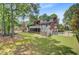 Expansive backyard with lush green lawn, mature trees, and a large deck at 4272 Persimmon Woods Dr, Charleston, SC 29420