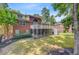 View of the large backyard with a brick house, spacious deck, and screened-in porch at 4272 Persimmon Woods Dr, Charleston, SC 29420