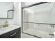 Modern bathroom showcasing sleek fixtures, a glass-enclosed tub-shower, and vanity with sink at 4272 Persimmon Woods Dr, Charleston, SC 29420