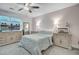Cozy bedroom features neutral tones, plush bedding, and ample natural light from a large window at 4272 Persimmon Woods Dr, Charleston, SC 29420