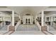 Exterior view of the Coosaw Creek Country Club entrance with stairs and covered porch at 4272 Persimmon Woods Dr, Charleston, SC 29420