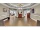 Well-lit hallway with tile flooring, decorative furniture, and double-door access to other rooms at 4272 Persimmon Woods Dr, Charleston, SC 29420