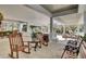 View of the clubhouse covered porch with rocking chairs and park benches at 4272 Persimmon Woods Dr, Charleston, SC 29420