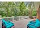 Inviting outdoor deck with comfortable seating and beautiful views of the surrounding trees at 4272 Persimmon Woods Dr, Charleston, SC 29420