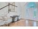 Open foyer featuring hardwood floors, staircase, console table and large window allowing natural light at 4272 Persimmon Woods Dr, Charleston, SC 29420
