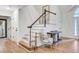 Bright foyer with hardwood floors, white trim staircase, console table, and decorative chair at 4272 Persimmon Woods Dr, Charleston, SC 29420