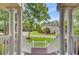 Inviting front porch featuring classic columns and views of the landscaped front yard and surrounding neighborhood at 4272 Persimmon Woods Dr, Charleston, SC 29420