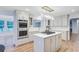 Modern kitchen with stainless steel appliances, custom cabinets, and a center island with cooktop at 4272 Persimmon Woods Dr, Charleston, SC 29420