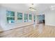 Bright living room boasts hardwood floors, multiple windows, and stylish lighting for a modern and airy feel at 4272 Persimmon Woods Dr, Charleston, SC 29420