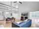 Bright living room features hardwood floors, tall ceilings, a modern ceiling fan, and large windows at 4272 Persimmon Woods Dr, Charleston, SC 29420