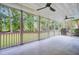 Large screened porch providing views of backyard, with two ceiling fans, and a grill at 4272 Persimmon Woods Dr, Charleston, SC 29420