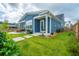 Backyard with lush green lawn, a stone patio with a grill, an outdoor screened-in patio, and a wooden fence at 436 Ripple Park Dr, Summerville, SC 29486