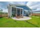 Backyard featuring an outdoor screened-in patio with outdoor chairs and a grill, plus a lush green lawn and blue siding at 436 Ripple Park Dr, Summerville, SC 29486