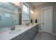 Elegant bathroom with double sinks, quartz countertops, and a glass-enclosed shower for a spa-like experience at 436 Ripple Park Dr, Summerville, SC 29486