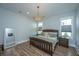 Cozy bedroom with a decorative chandelier, neutral walls, and a comfortable bed, creating a relaxing atmosphere at 436 Ripple Park Dr, Summerville, SC 29486