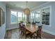 Charming dining room with a wooden table, six chairs, and large windows offering an abundance of natural light at 436 Ripple Park Dr, Summerville, SC 29486