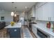 Stylish kitchen featuring white cabinets, stainless steel appliances, a center island, and quartz countertops at 436 Ripple Park Dr, Summerville, SC 29486