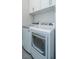 The laundry room features a front loading washing machine and dryer, along with white cabinets and light-grey walls at 436 Ripple Park Dr, Summerville, SC 29486